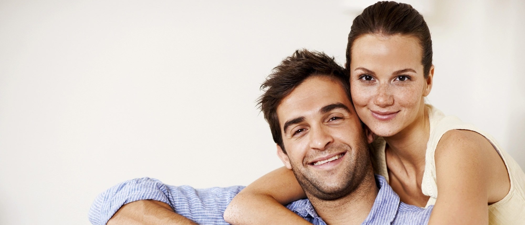 Portrait of an attractive young couple with a laptop at home